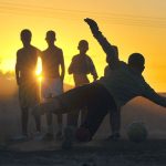 Kids Playing Football at Sunset Kids Playing Football at Sunset